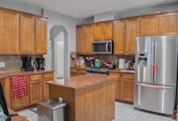 a kitchen with stainless steel appliances and wooden cabinets