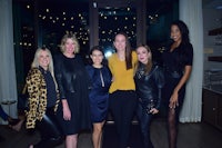 a group of women posing for a photo at an event